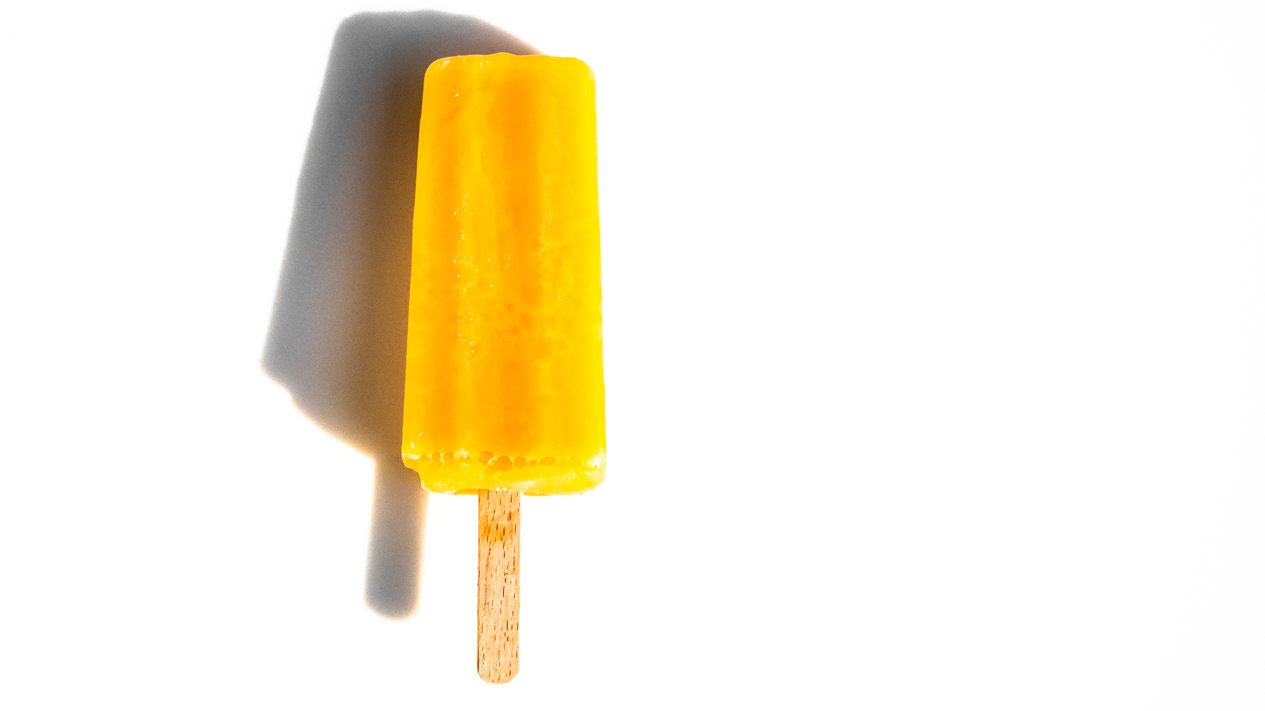 yellow apple and carrot popsicle treat for dogs