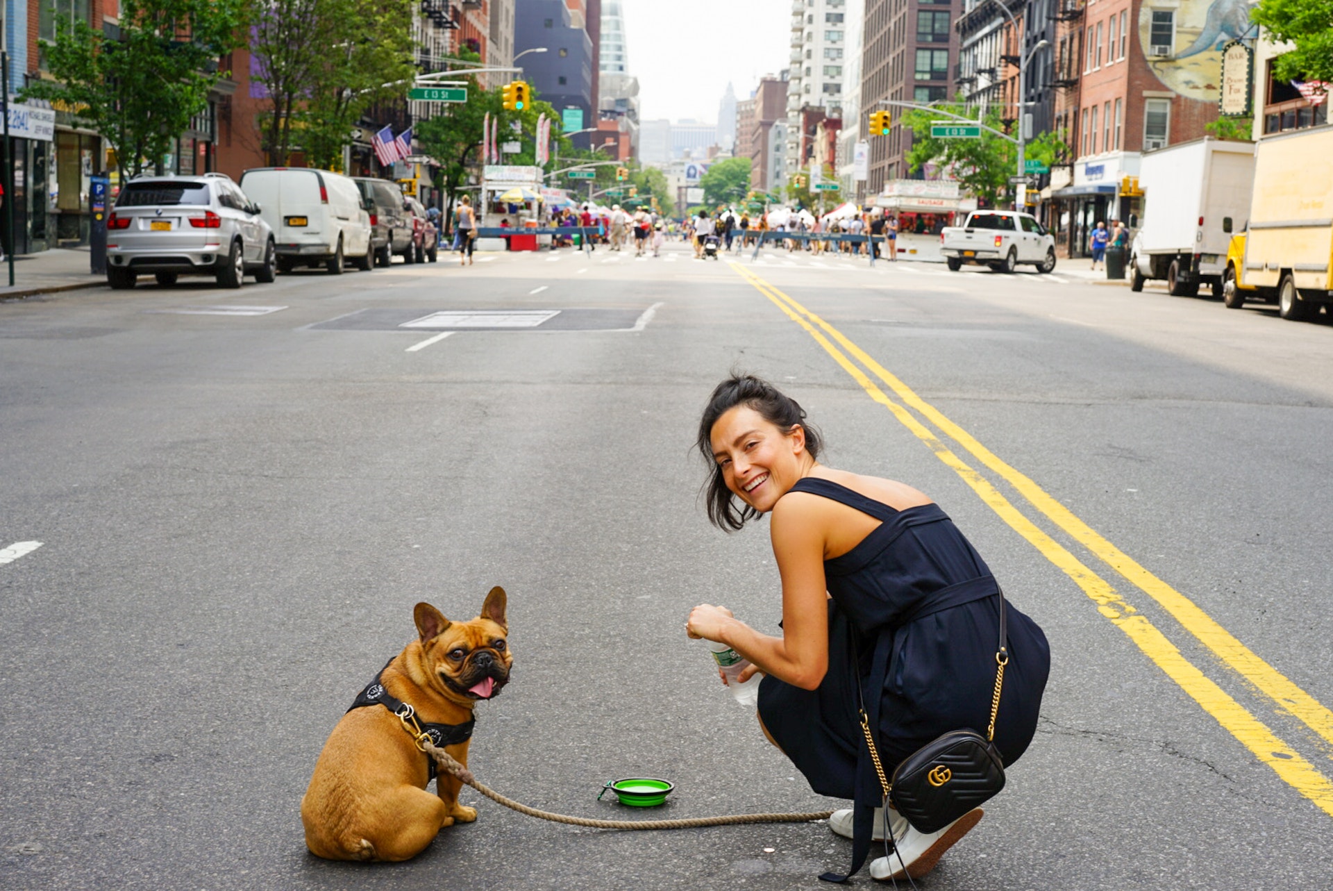 french bulldog and woman on street 