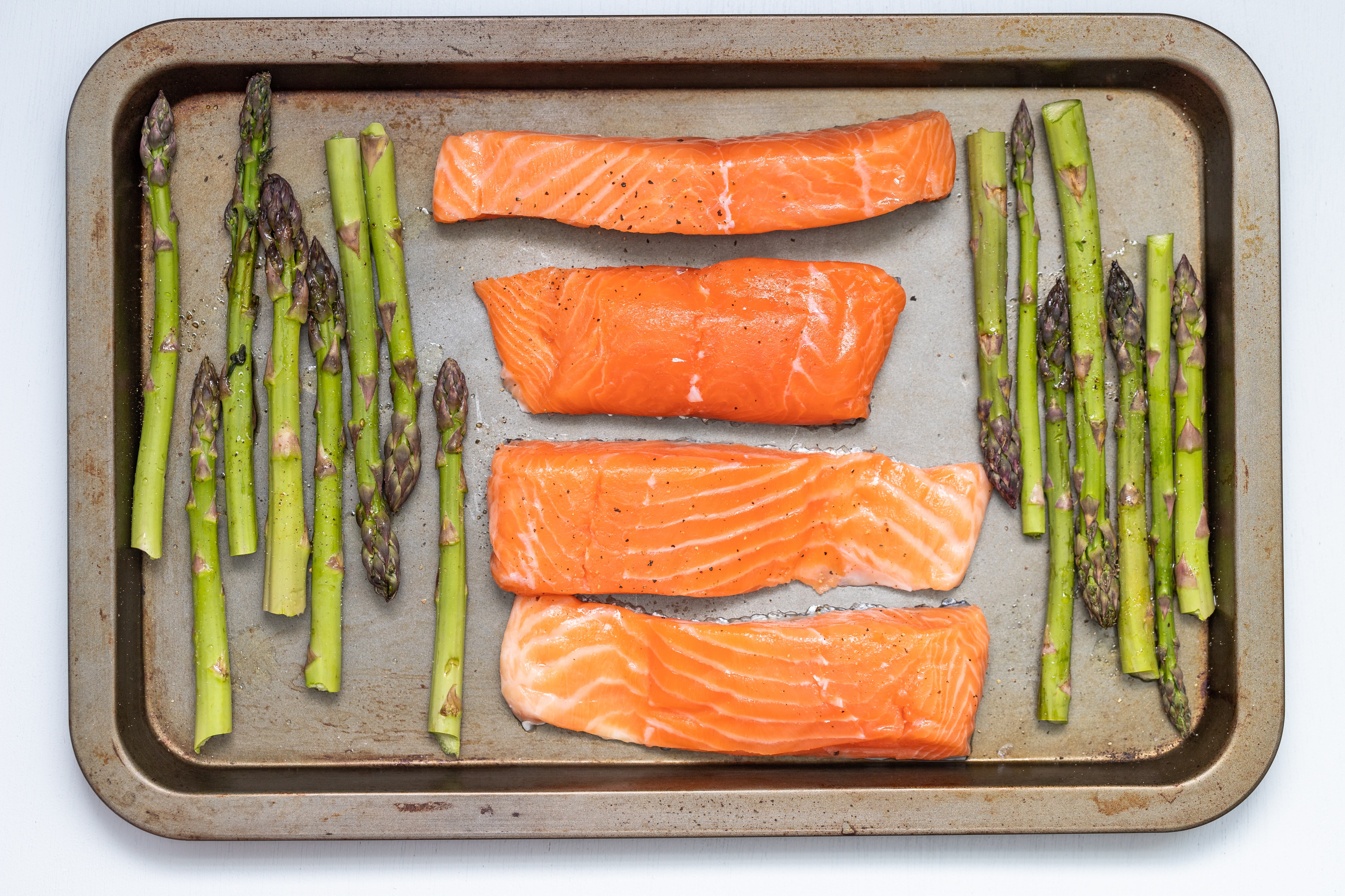fish and asparagus on an oven tray