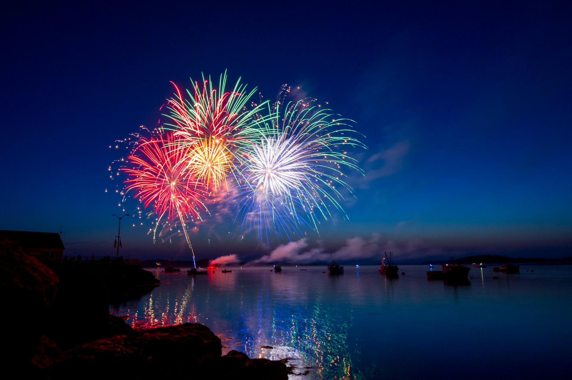 fireworks seen above a lake