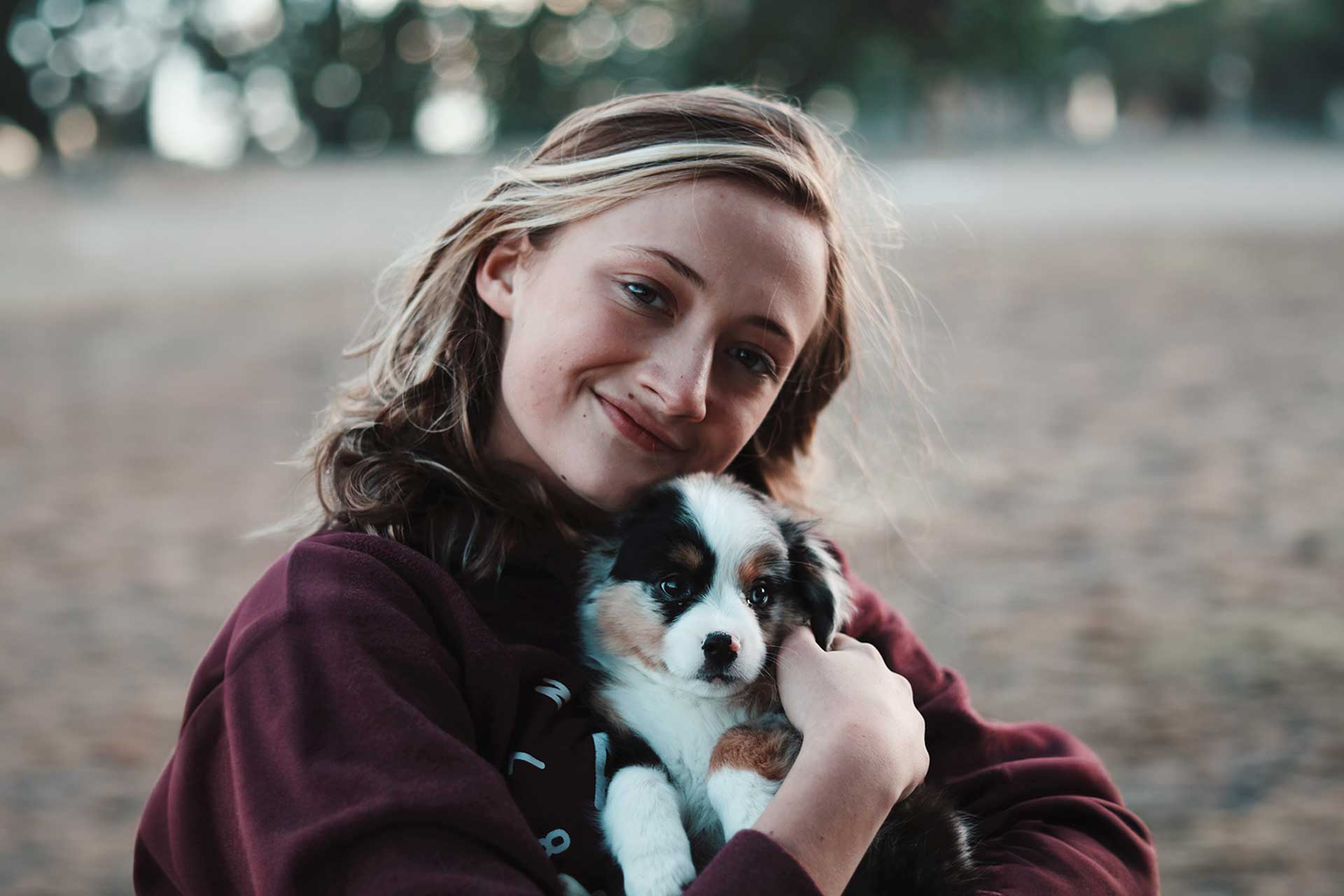 happy woman holding puppy