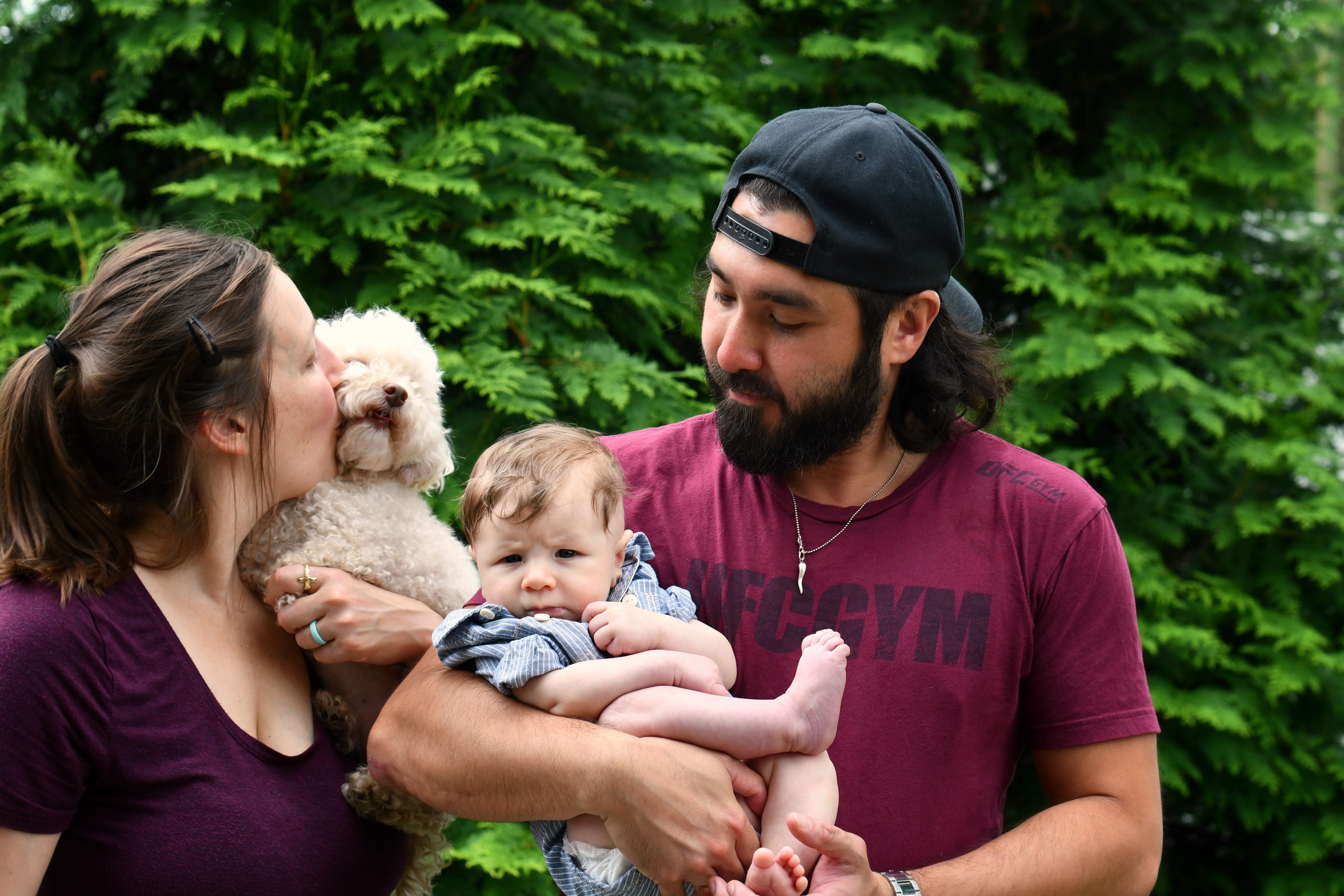 family with a baby and a maltipoo doodle