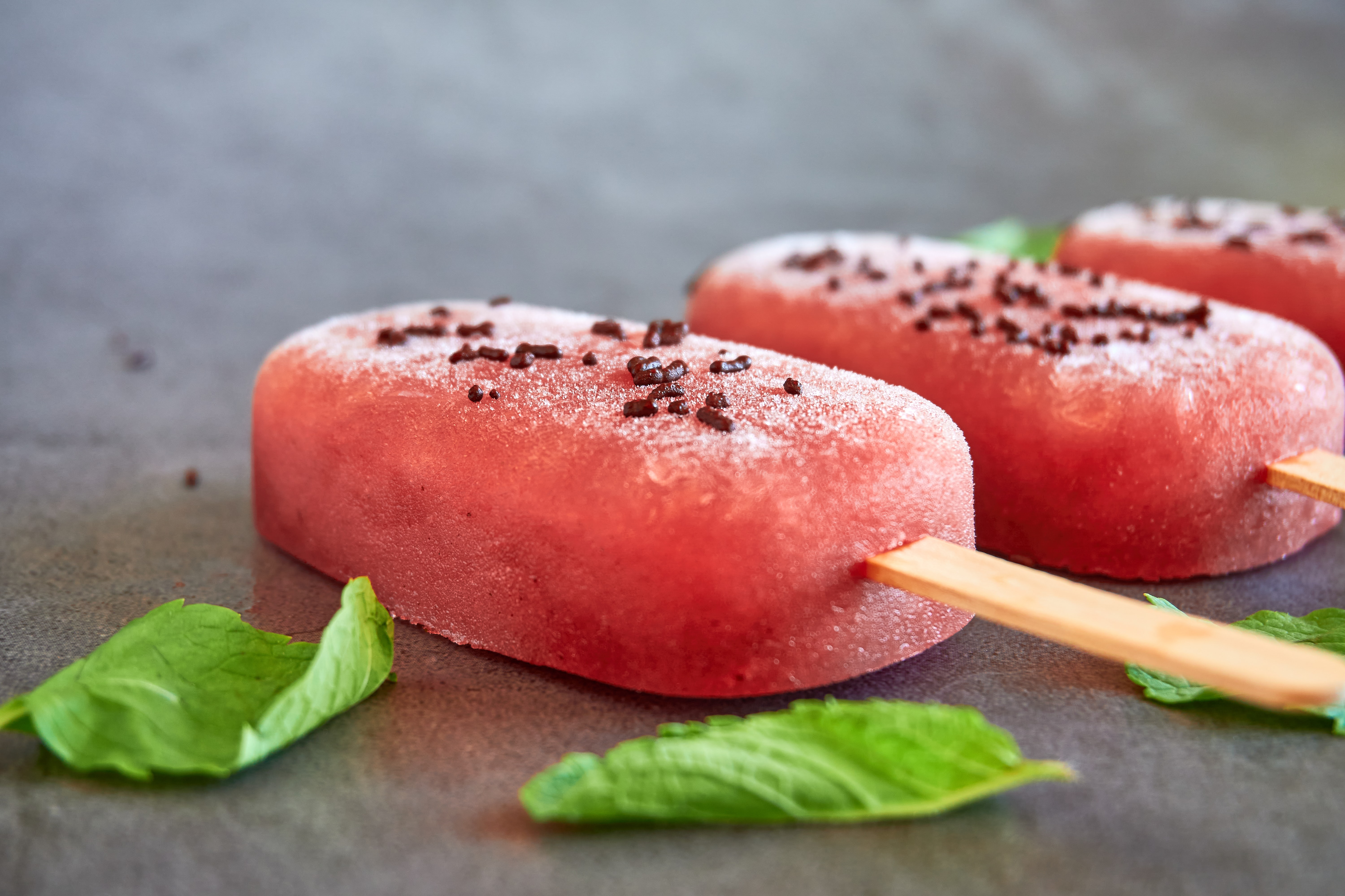watermelon popsicles on a gray background