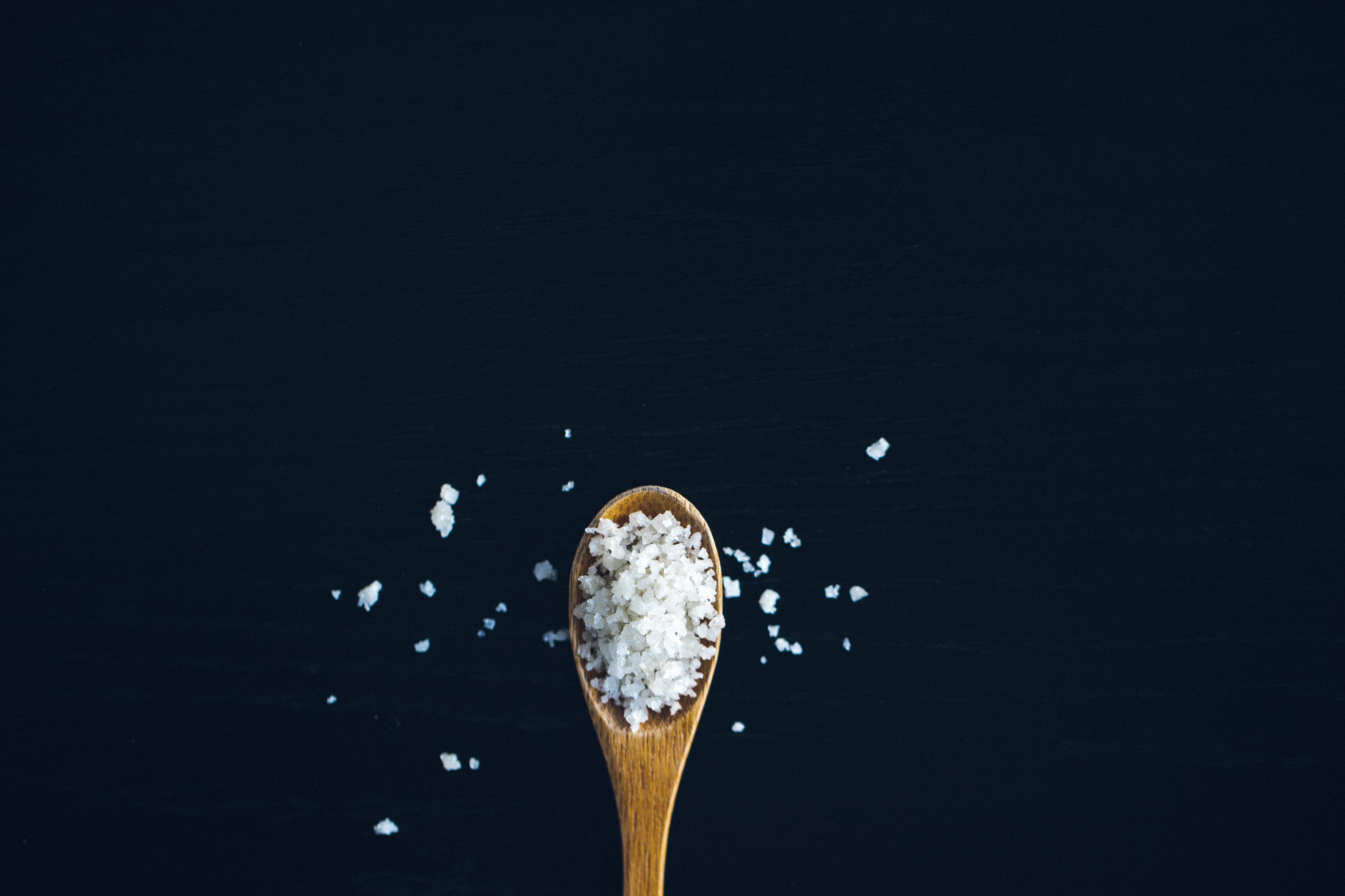 wooden spoon filled with salt