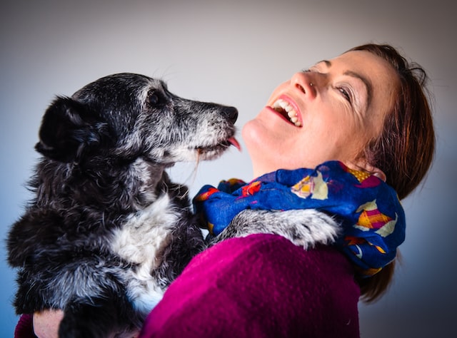 dog licking woman's face