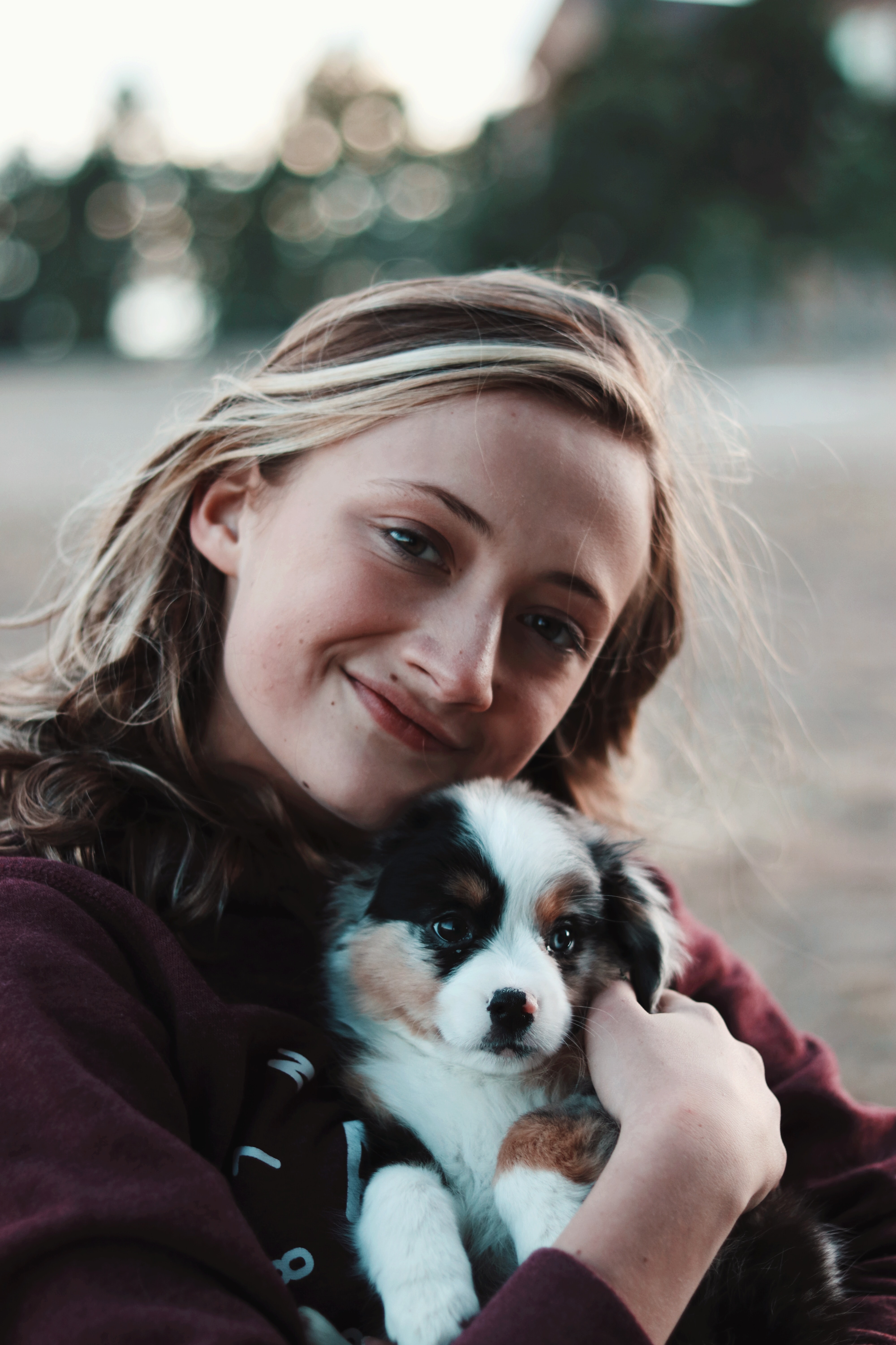 happy woman holding puppy